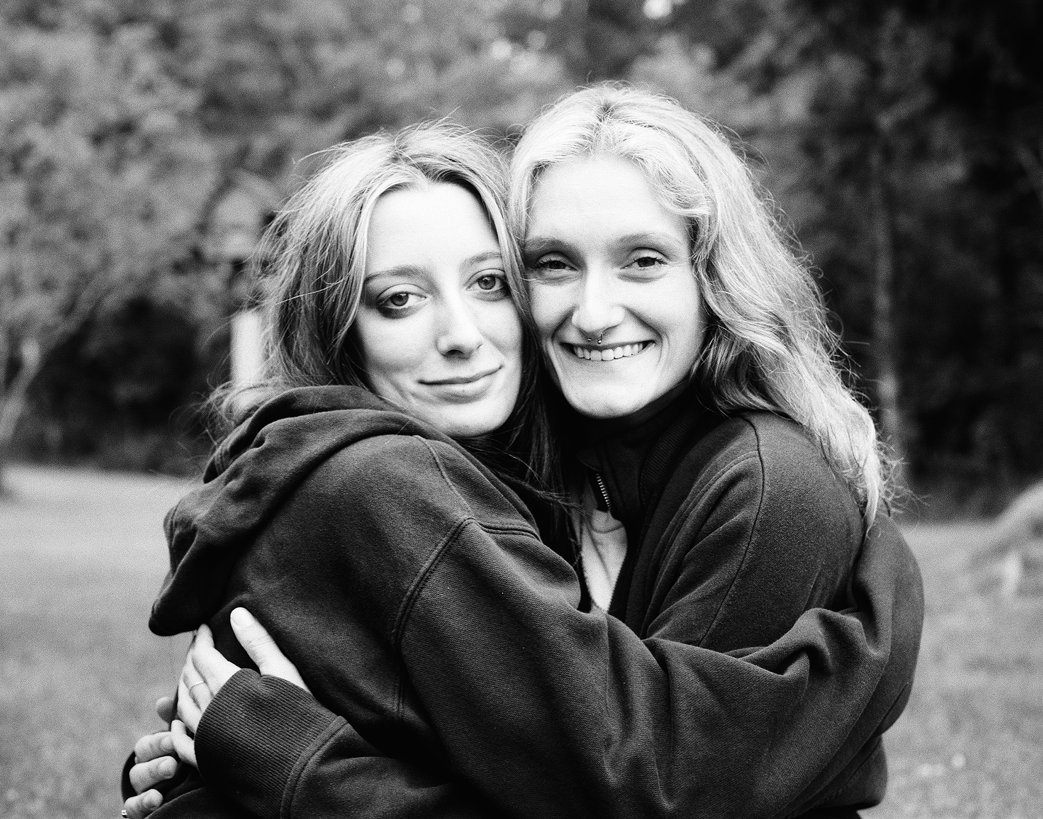 Portrait of two young women with 1970s hairstyles smiling outdoors