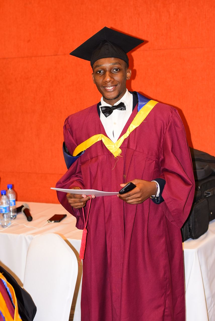 Male engineering graduate in maroon graduation gown