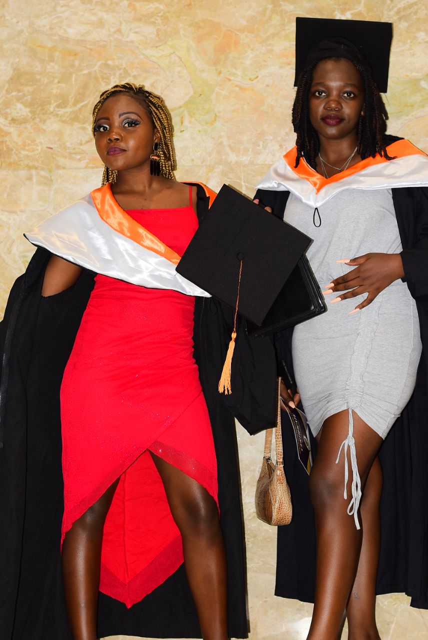 Two female graduates in graduation gowns