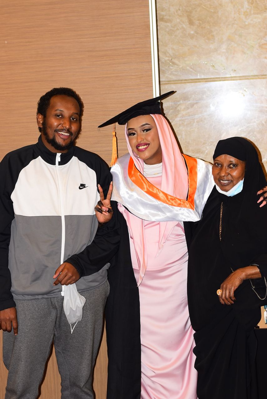 Female graduate celebrating with family