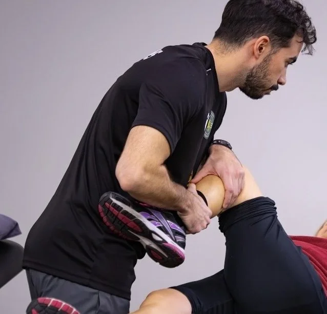 Physical therapist performing a hands-on stretch with a patient