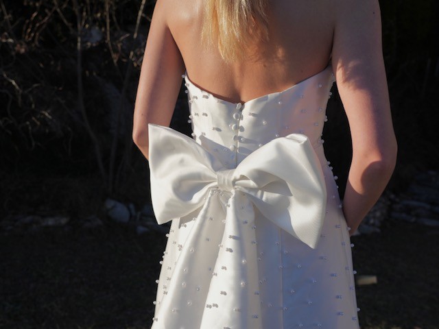 Bride wearing a Van der Vlis bridal gown with a bow at the back