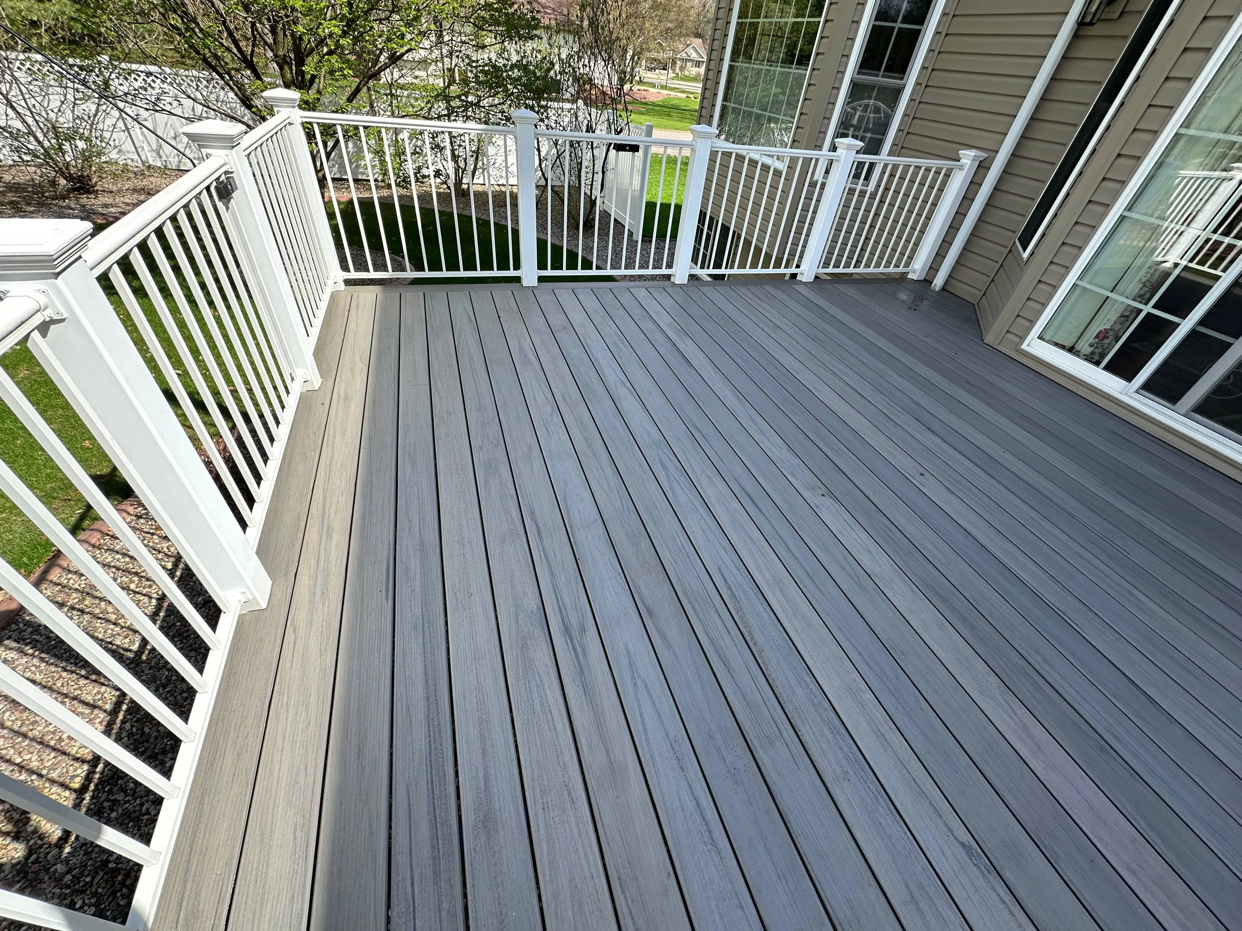 Composite Deck with Curved Railings — Deck remodel project completed by Wilbur's Home Remodeling in Eau Claire, WI