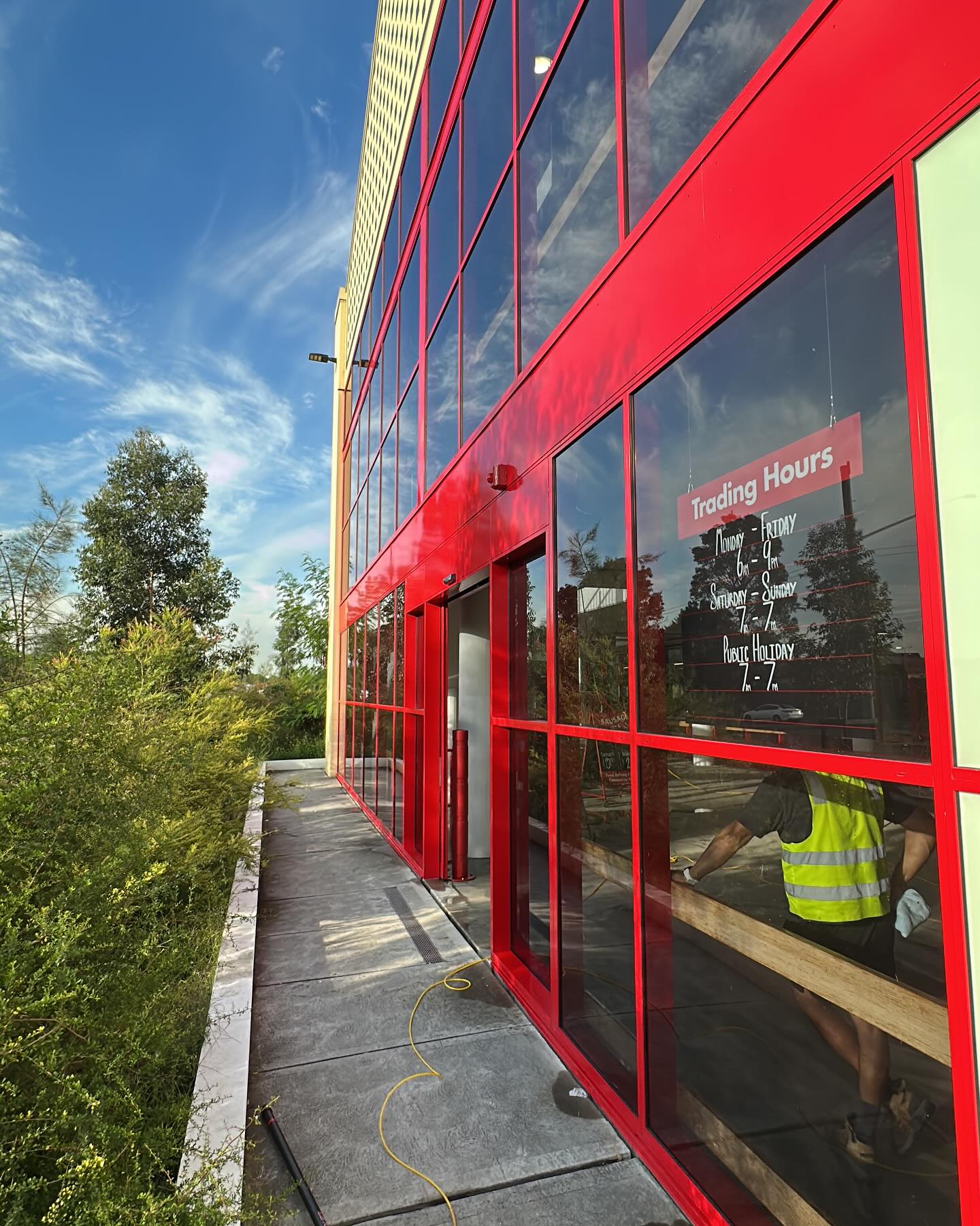 Commercial storefront window cleaning in progress