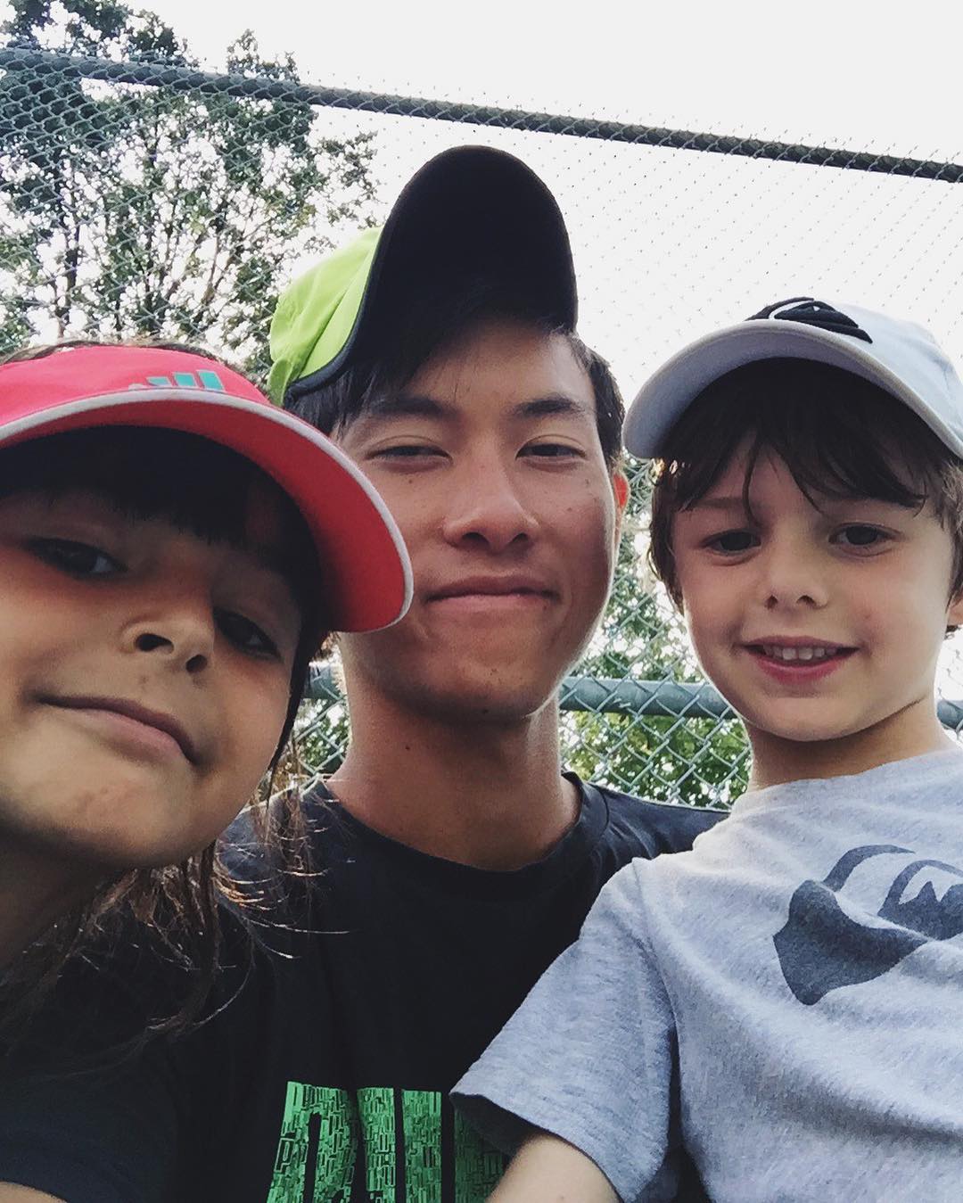 Tennis coach with young students