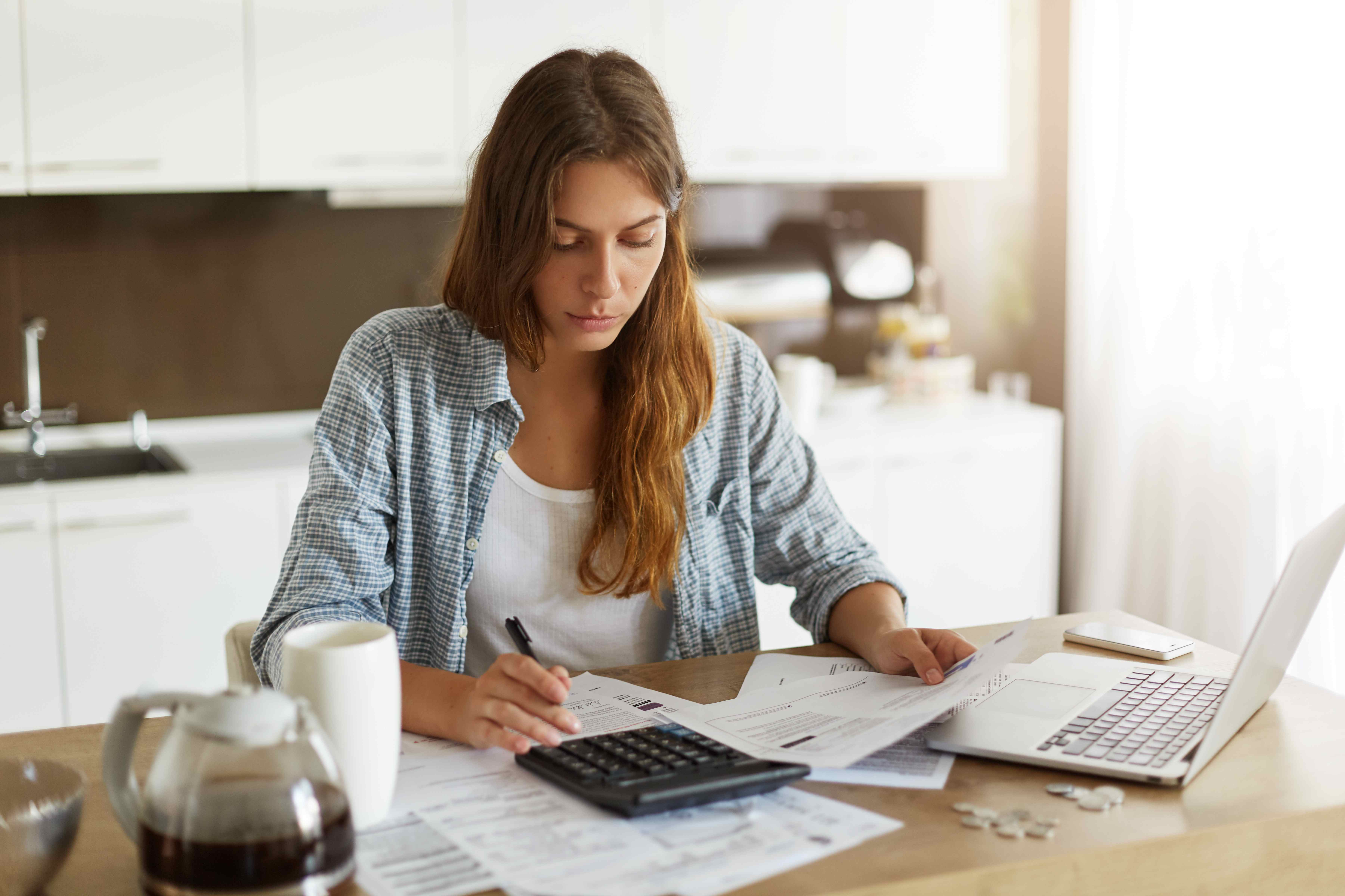 Woman checking budget and doing taxes