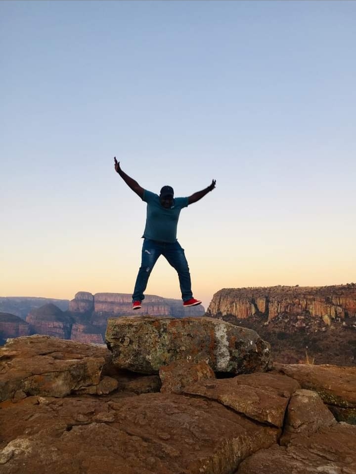 Traveler celebrating at canyon viewpoint